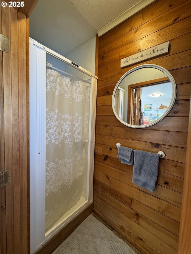 bathroom with wooden walls and curtained shower