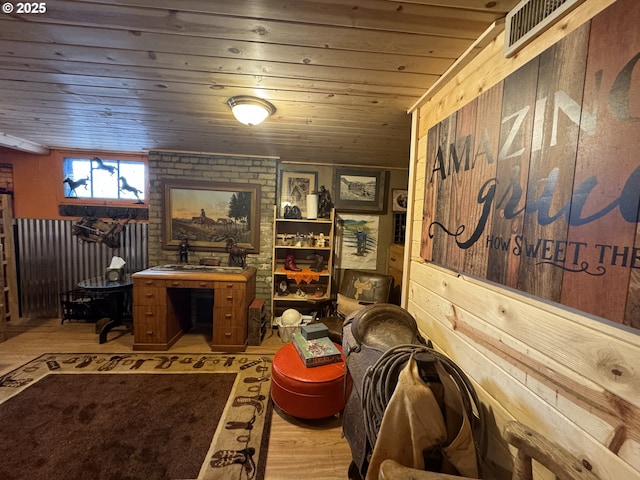 home office featuring visible vents, wood ceiling, wood finished floors, and wood walls