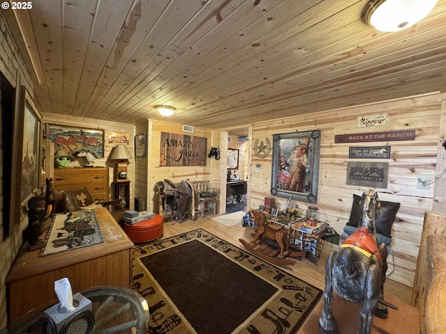 interior space with wooden ceiling, wood finished floors, and wood walls