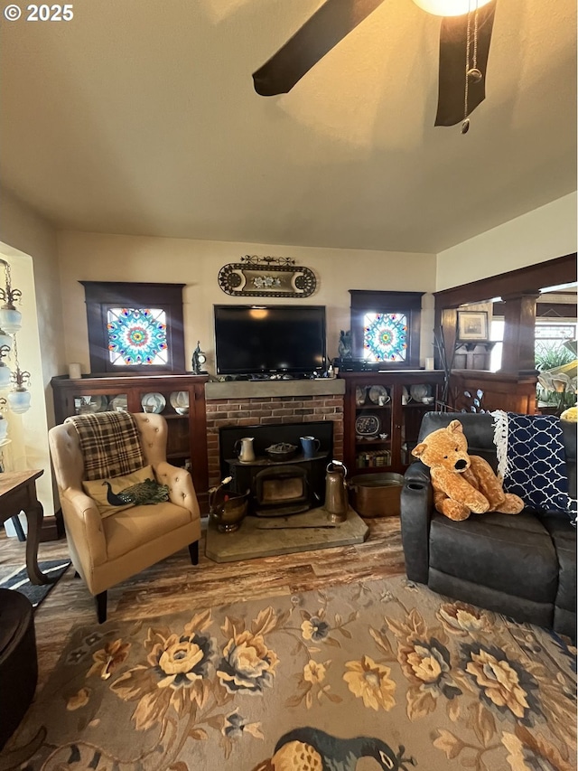 living room featuring a ceiling fan and wood finished floors