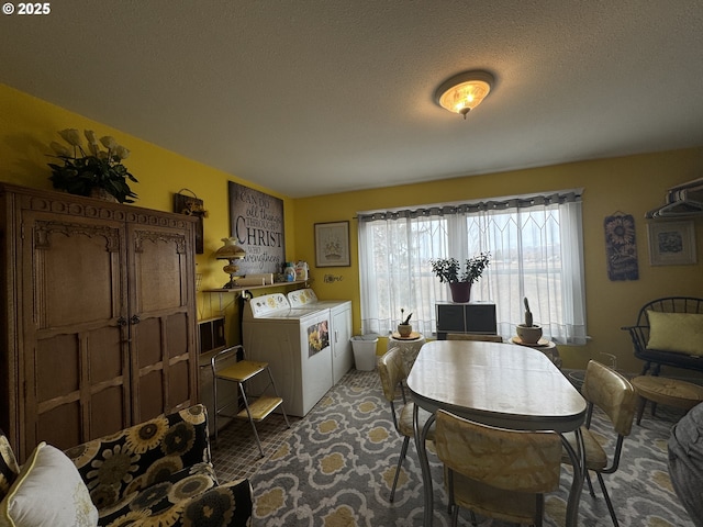 dining space with washer and dryer and a textured ceiling