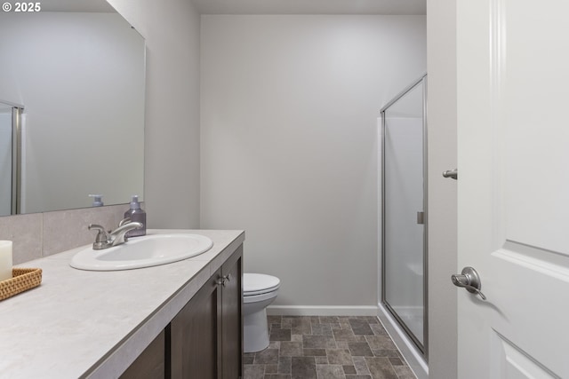 11449 SW Mont Blanc St, Wilsonville, OR 97070 - bathroom with vanity, toilet, a stall shower, stone finish floors, and baseboards