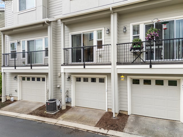 11449 SW Mont Blanc St, Wilsonville, OR 97070 - view of front of home with an attached garage, central air condition unit, and driveway