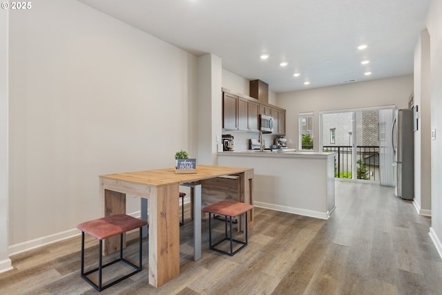 11449 SW Mont Blanc St, Wilsonville, OR 97070 - dining room featuring light wood finished floors, baseboards, and recessed lighting