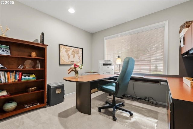 office featuring baseboards and light colored carpet