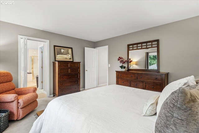 bedroom with light carpet and ensuite bathroom