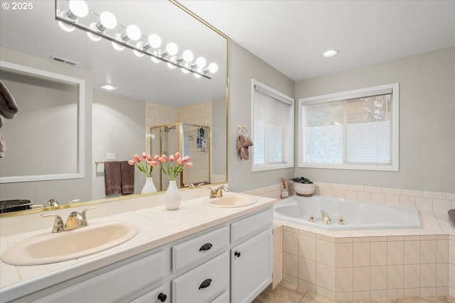 bathroom with a garden tub, a sink, visible vents, and a shower stall