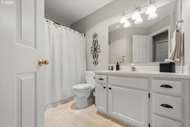 full bathroom with toilet, tile patterned floors, and vanity