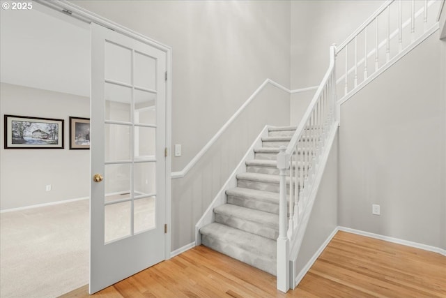 stairway featuring baseboards and wood finished floors