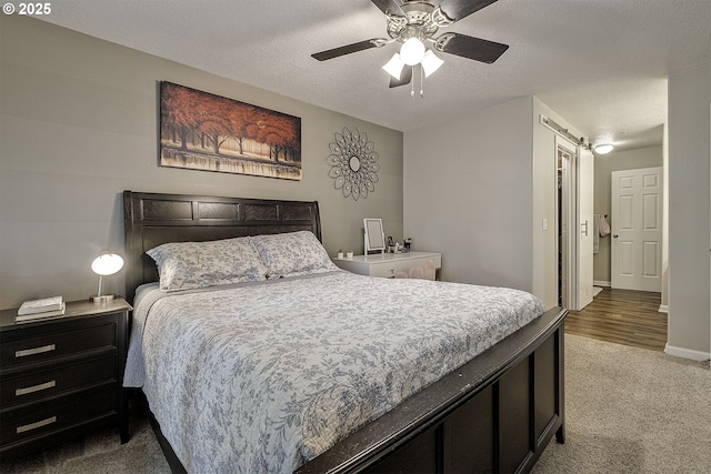 carpeted bedroom with baseboards and ceiling fan