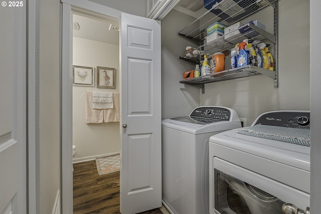 washroom with laundry area, wood finished floors, and washing machine and clothes dryer