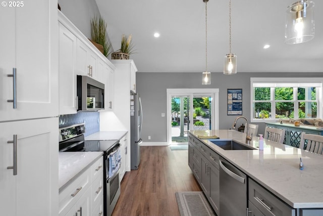 83591 Sauter Dr, Florence, OR 97439 - kitchen with stainless steel appliances, an island with sink, dark wood-style floors, recessed lighting, and healthy amount of natural light