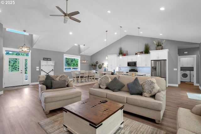 83591 Sauter Dr, Florence, OR 97439 - living area with washer / clothes dryer, high vaulted ceiling, ceiling fan, light wood-type flooring, and recessed lighting