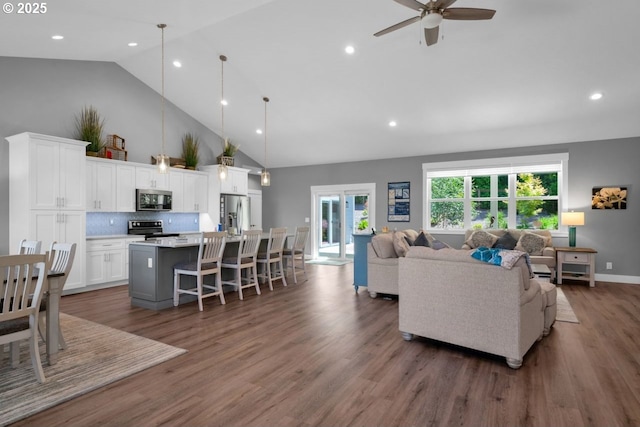 83591 Sauter Dr, Florence, OR 97439 - living room featuring high vaulted ceiling, a ceiling fan, recessed lighting, and wood finished floors