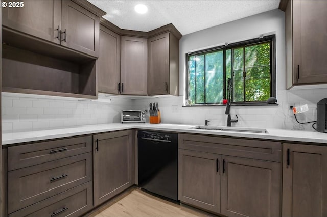 9532 SW Whitford Ln, Beaverton, OR 97008 - kitchen with dishwasher, tasteful backsplash, light countertops, a textured ceiling, and light wood-type flooring