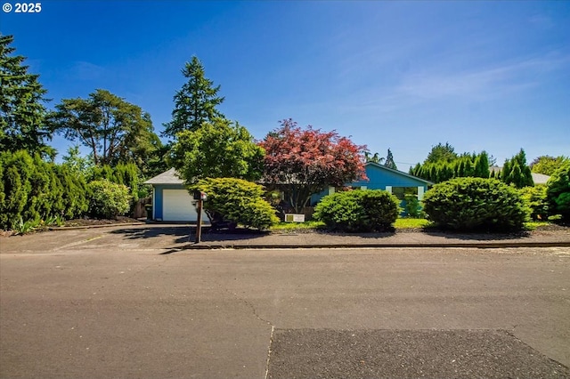 9532 SW Whitford Ln, Beaverton, OR 97008 - view of property hidden behind natural elements featuring a garage