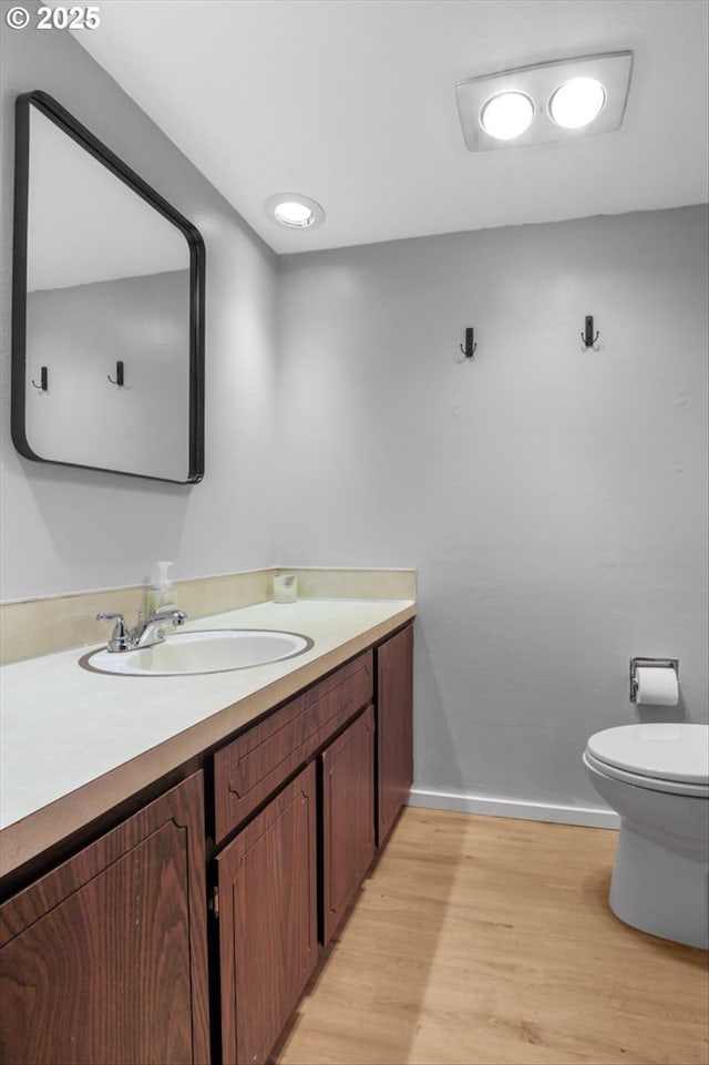9532 SW Whitford Ln, Beaverton, OR 97008 - bathroom featuring vanity, wood finished floors, toilet, and baseboards