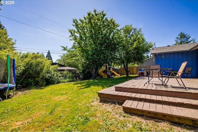 9532 SW Whitford Ln, Beaverton, OR 97008 - view of yard with a trampoline, a playground, a wooden deck, and outdoor dining space