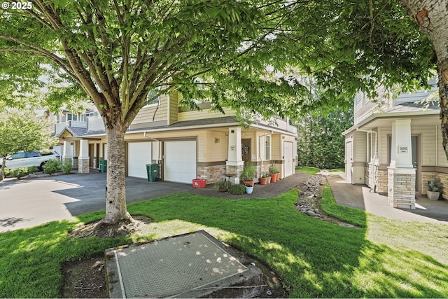 14600 SW Magpie Ln Unit 102, Beaverton, OR 97007 - view of front of property with stone siding, driveway, an attached garage, and a front yard