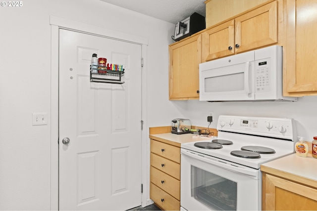 14600 SW Magpie Ln Unit 102, Beaverton, OR 97007 - kitchen featuring white appliances, light brown cabinets, and light countertops