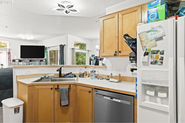 14600 SW Magpie Ln Unit 102, Beaverton, OR 97007 - kitchen with white fridge with ice dispenser, dishwasher, a sink, a textured ceiling, and light countertops