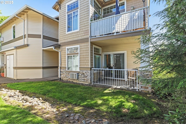 14600 SW Magpie Ln Unit 102, Beaverton, OR 97007 - rear view of property with a balcony, a yard, and stone siding