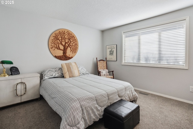 carpeted bedroom featuring baseboards, visible vents, and a textured ceiling