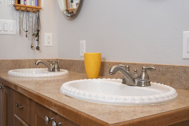 bathroom featuring a sink and double vanity