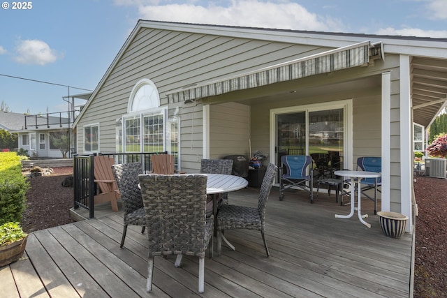 wooden deck featuring central air condition unit and outdoor dining area