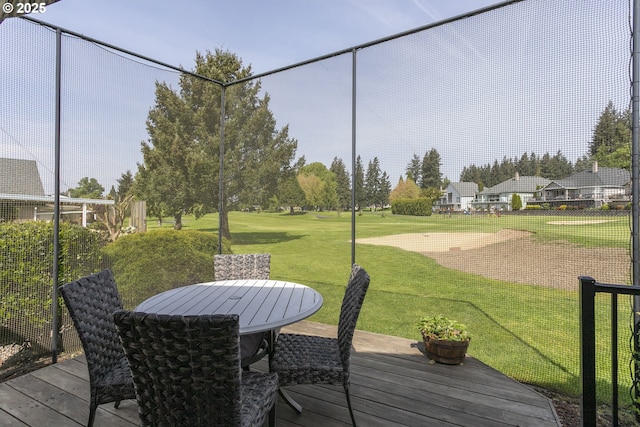 wooden terrace with a yard and outdoor dining area