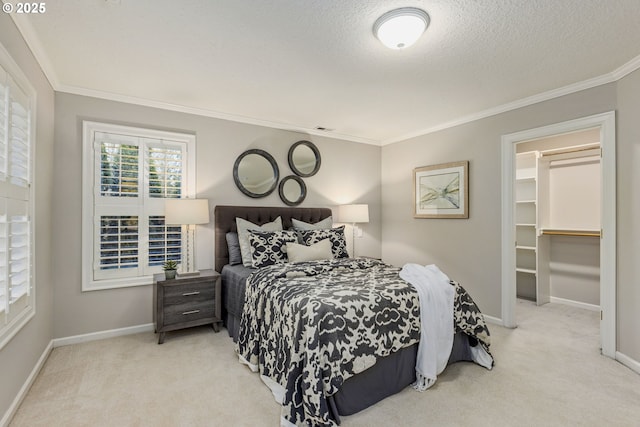 bedroom featuring carpet flooring, crown molding, and baseboards