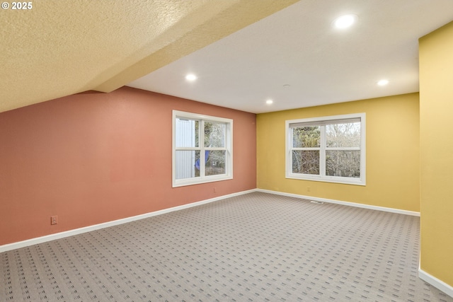 additional living space featuring carpet, baseboards, and recessed lighting