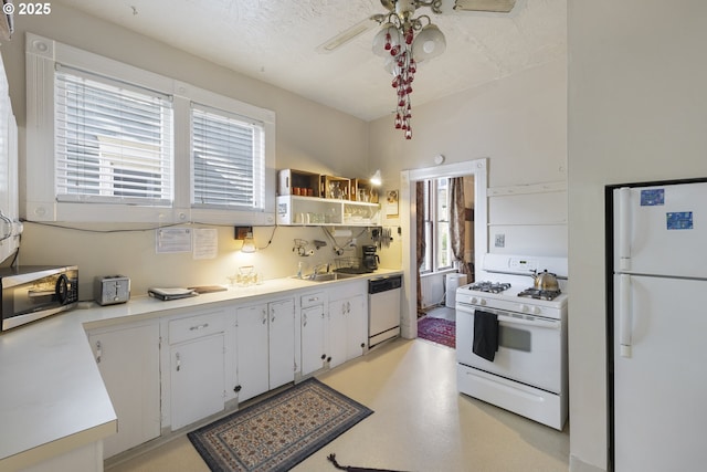 1817 SE 12th Ave, Portland, OR 97214 - kitchen featuring white appliances, a ceiling fan, a sink, light countertops, and white cabinetry