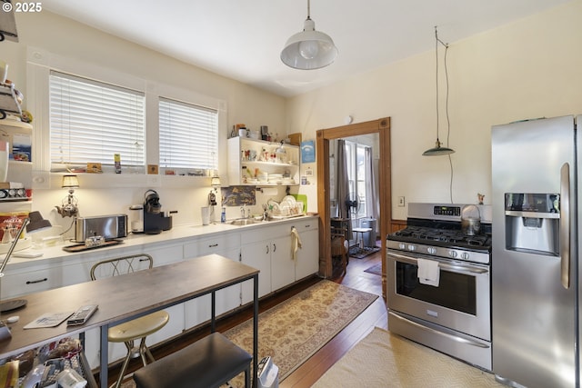 1817 SE 12th Ave, Portland, OR 97214 - kitchen with appliances with stainless steel finishes, wood finished floors, light countertops, open shelves, and white cabinets