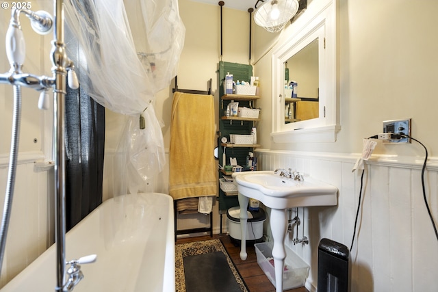 1817 SE 12th Ave, Portland, OR 97214 - full bathroom featuring a tub, wainscoting, and wood finished floors