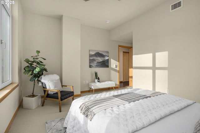 bedroom featuring light colored carpet, visible vents, and baseboards