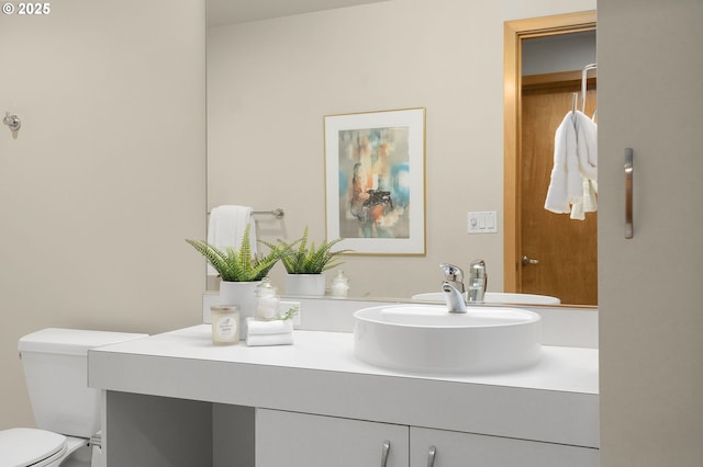 bathroom featuring toilet and vanity