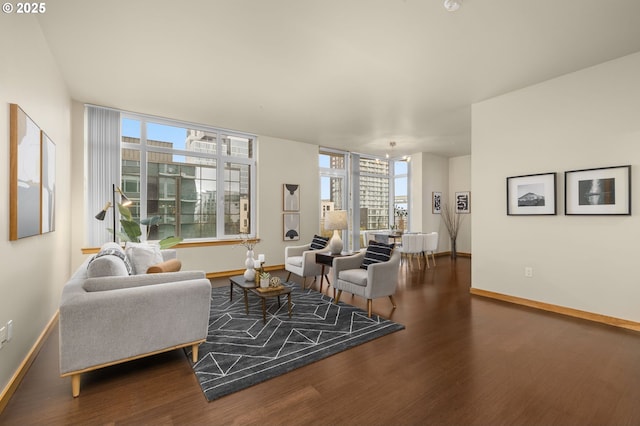 living room featuring baseboards and dark wood-style flooring