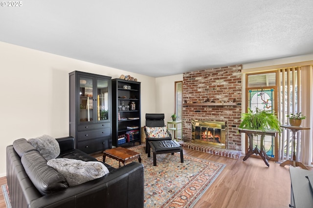 living area with a fireplace and wood finished floors