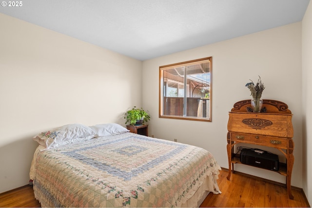 bedroom featuring wood finished floors