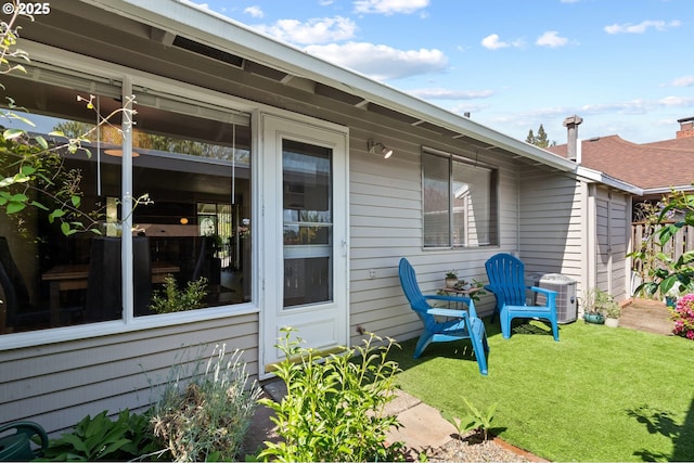 exterior space featuring a lawn and central AC