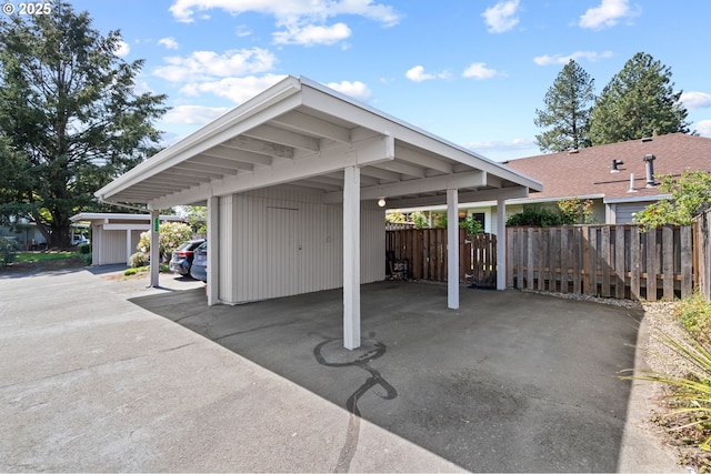 exterior space featuring fence and a carport
