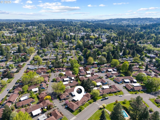 drone / aerial view with a view of trees and a residential view