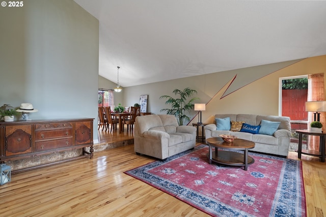 living area with lofted ceiling and wood finished floors