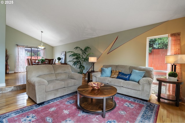 living area featuring lofted ceiling and wood finished floors