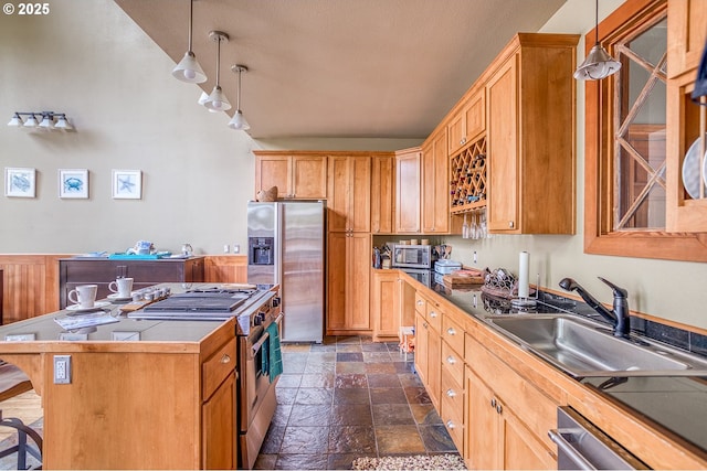 3360 NW Oceanview Dr, Newport, OR 97365 - kitchen with stainless steel appliances, stone tile floors, pendant lighting, a kitchen island, and a sink