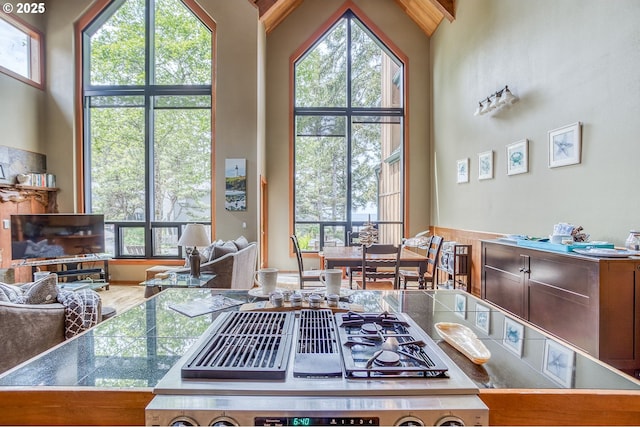 3360 NW Oceanview Dr, Newport, OR 97365 - kitchen with healthy amount of natural light, tile countertops, stove, open floor plan, and high vaulted ceiling