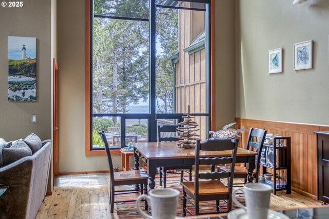 3360 NW Oceanview Dr, Newport, OR 97365 - dining space featuring light wood-type flooring and a wainscoted wall