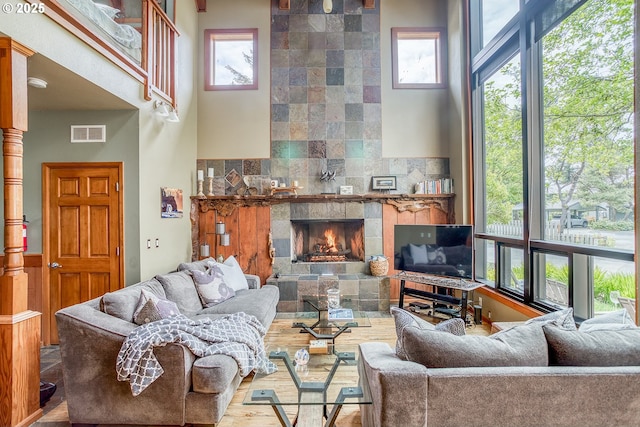 3360 NW Oceanview Dr, Newport, OR 97365 - living area featuring wood finished floors, a fireplace, and a high ceiling