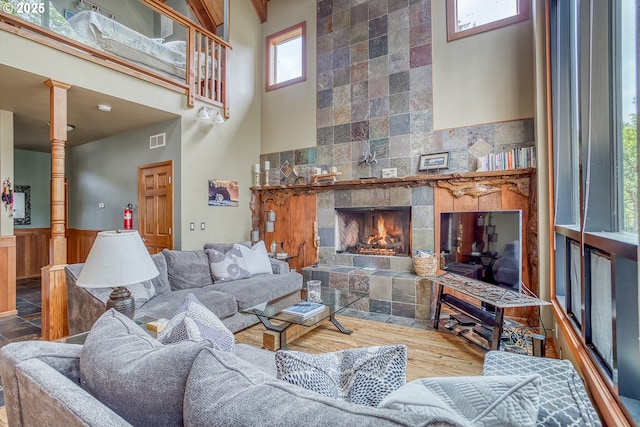 3360 NW Oceanview Dr, Newport, OR 97365 - living area with a high ceiling, a tile fireplace, wainscoting, and decorative columns